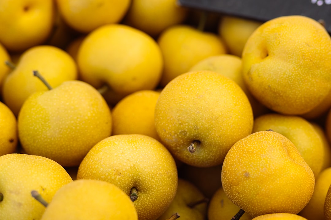 Asian Pear - a pile of yellow apples sitting next to each other