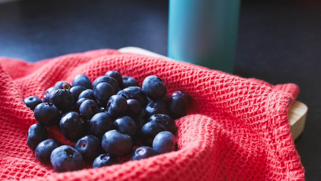 Blueberry - a red cloth with a bunch of blueberries in it