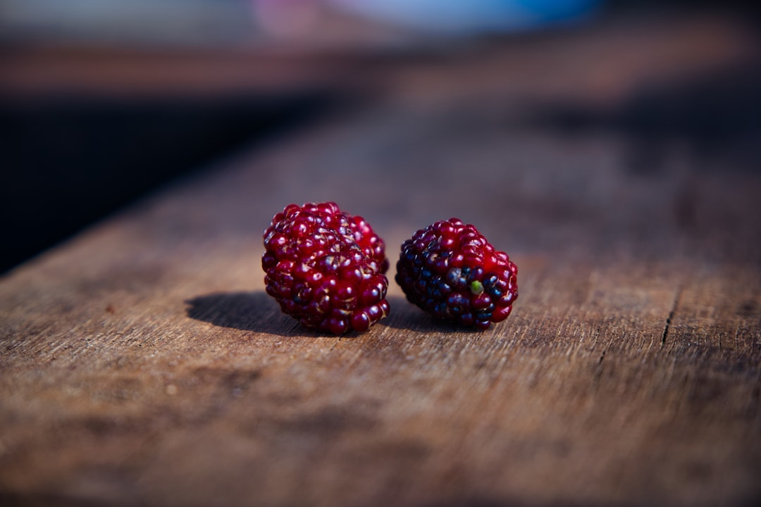 Boysenberry - red raspberry on brown wooden table