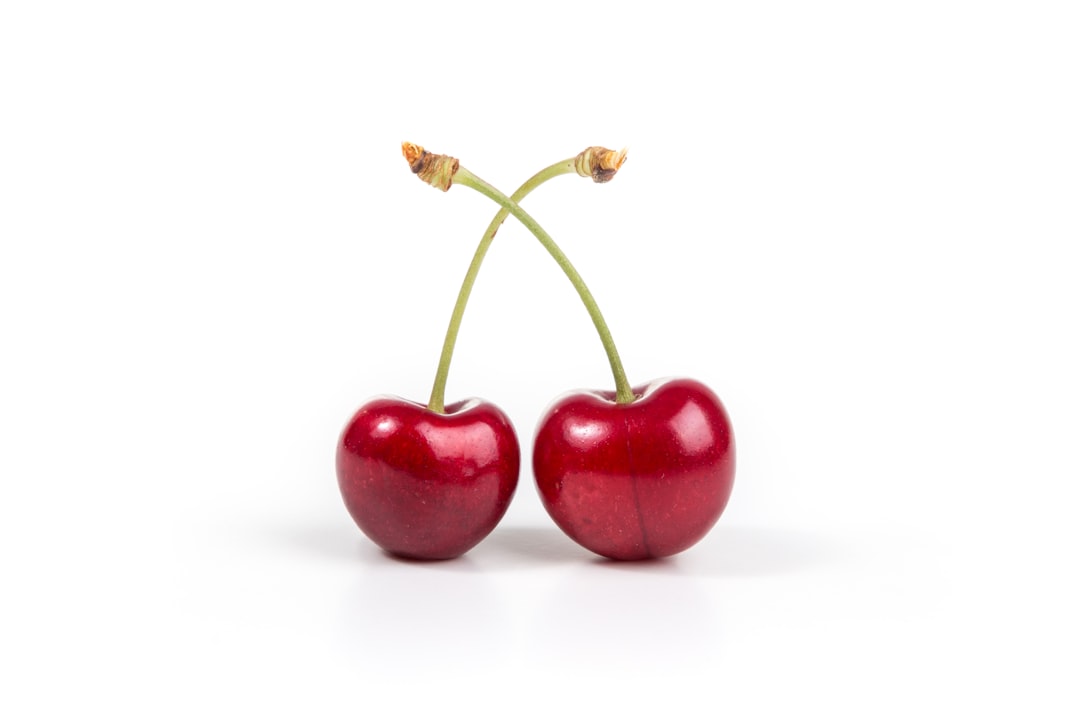 Cherry - two cherries on white surface