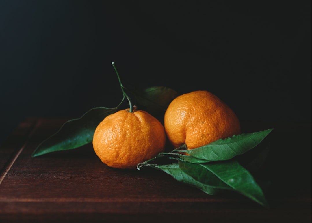 Clementine - orange fruit on brown wooden table