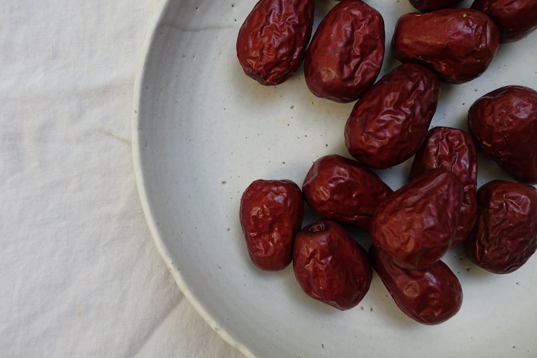 Date - dried fruits on white ceramic plate