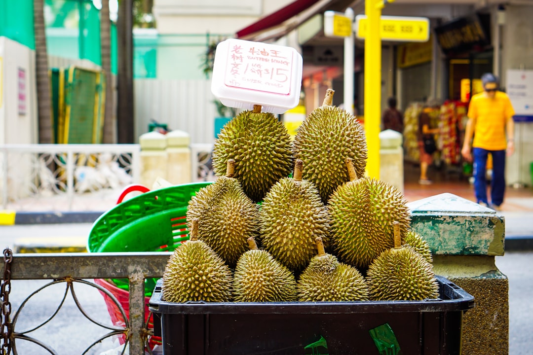 Durian - a pile of fruit sitting on top of a table