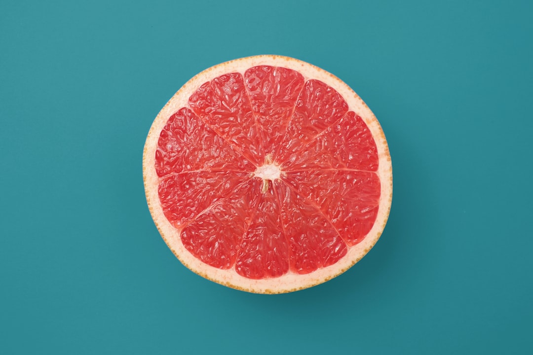 Grape - sliced orange fruit on blue background