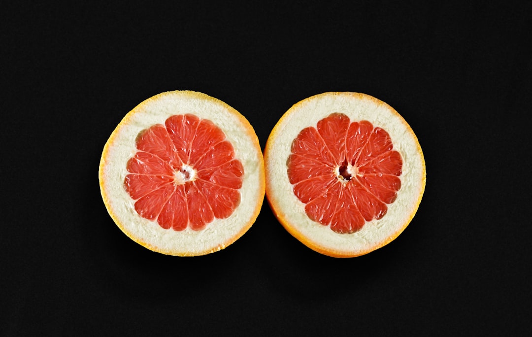 Grapefruit - a grapefruit cut in half on a black background