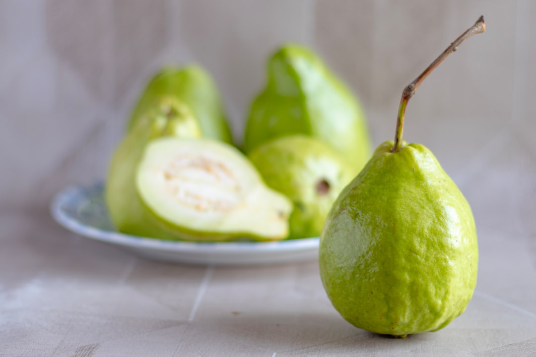 Guava - green fruit on white ceramic plate
