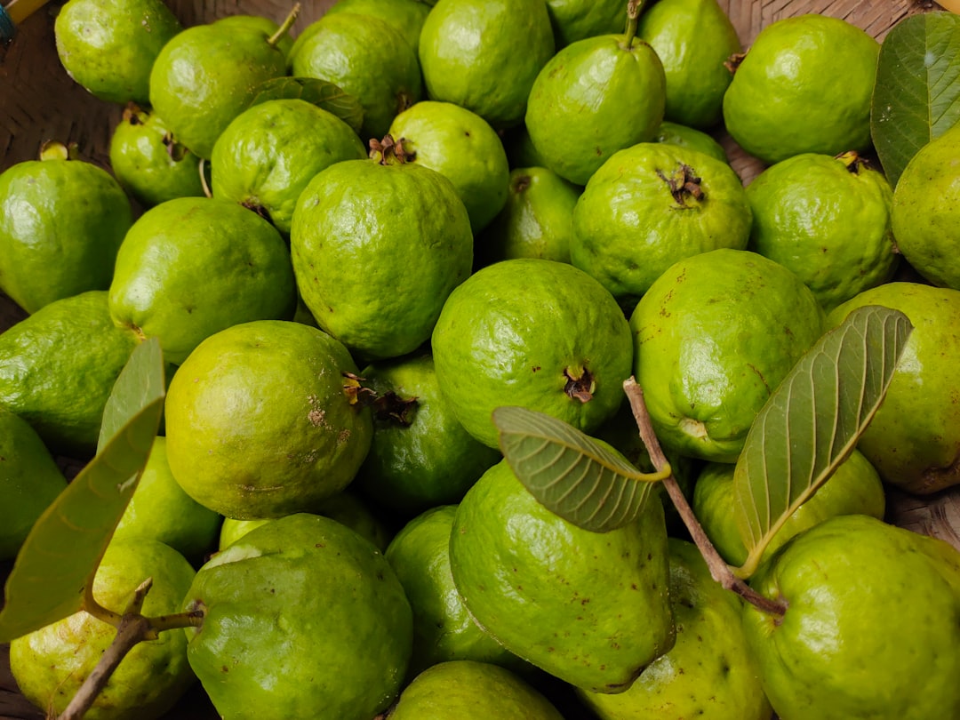 Guava - a basket full of limes with green leaves