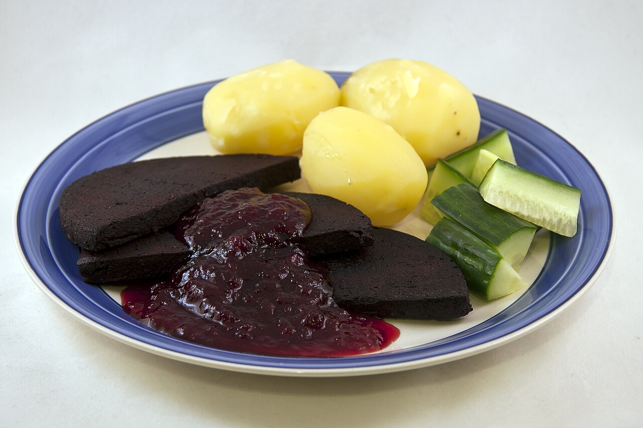 Lingonberry - Swedish black pudding, blodpudding, served with boiled potatoes, lingonberry jam, and cucumber.