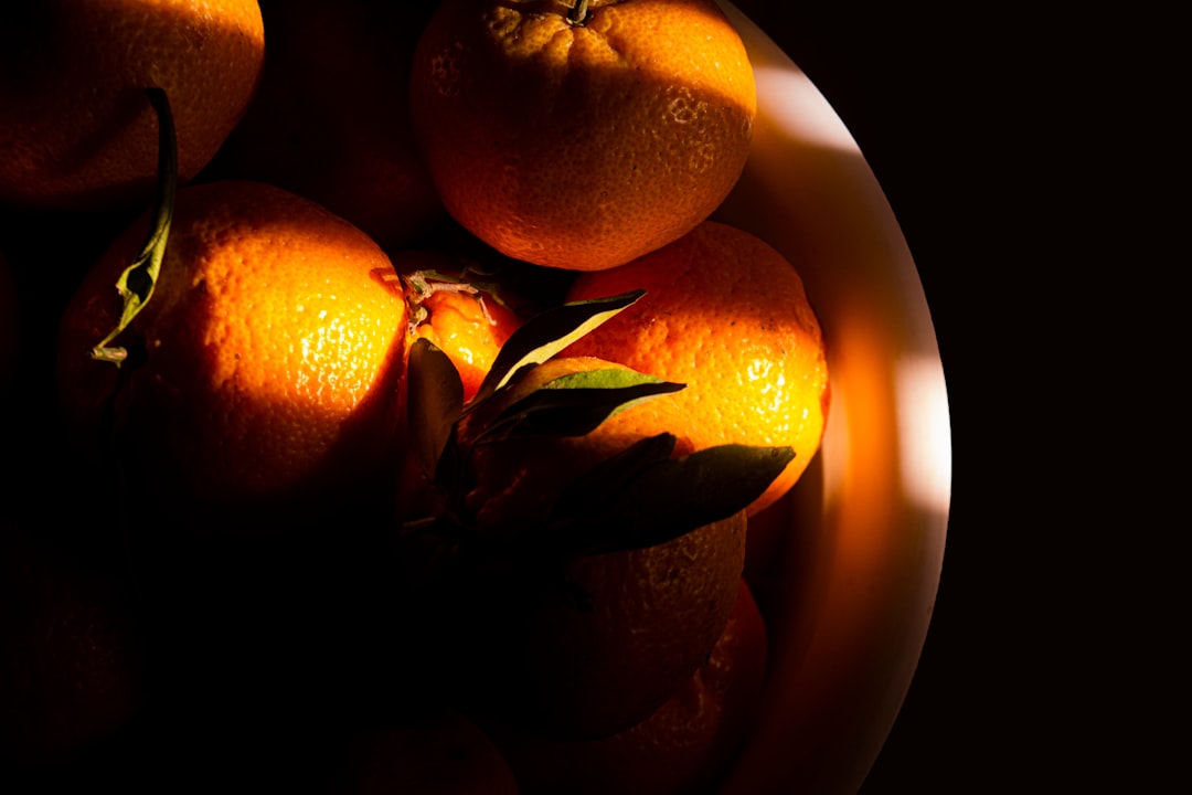 Mandarin - orange fruit in brown ceramic bowl