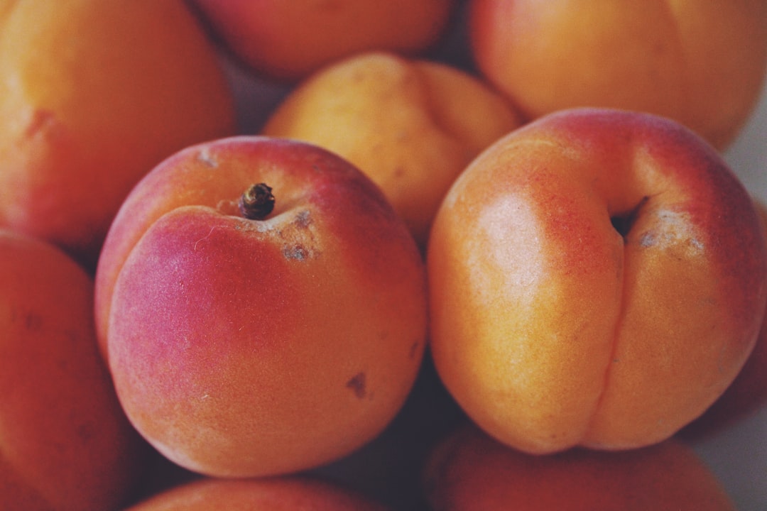 Peach - red apple fruit on brown wooden table
