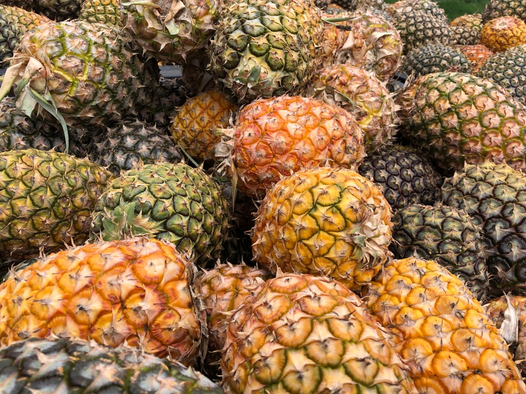 Pineapple - a pile of pineapples sitting next to each other