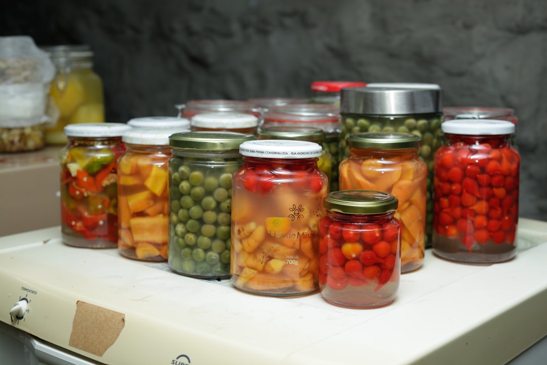 Sour Cherry - Jars of preserved vegetables and fruits on a shelf.