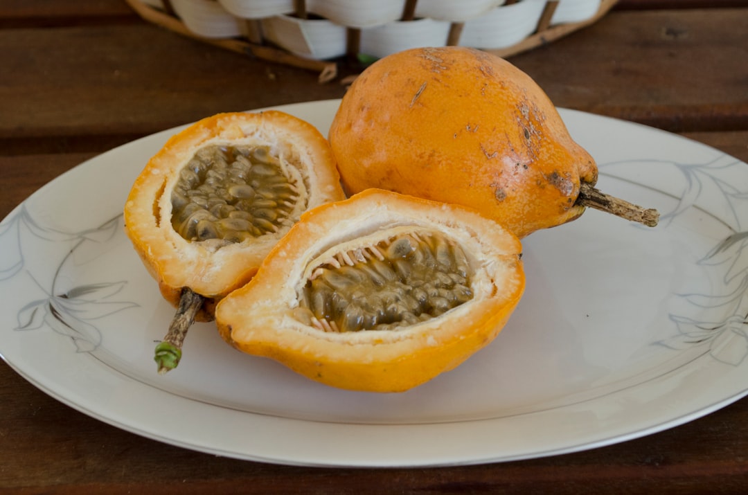 Tamarillo - orange fruit on white ceramic plate